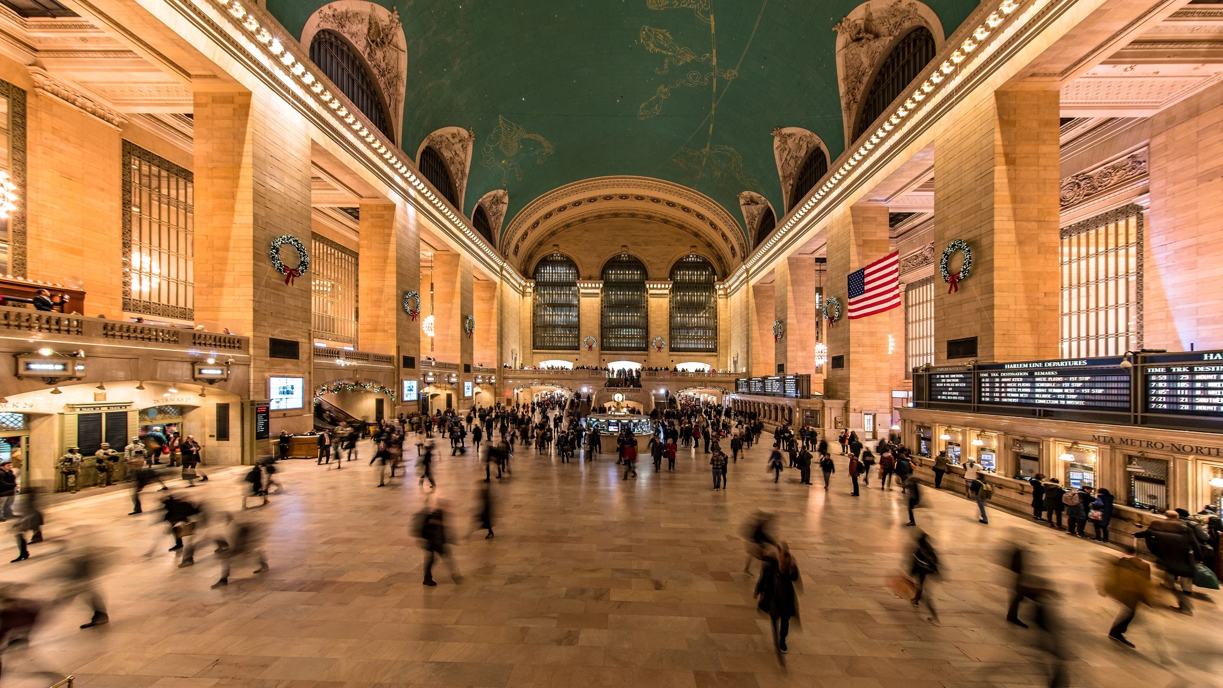 Dozens of rush hour patrons walk through grand central station in New York City.