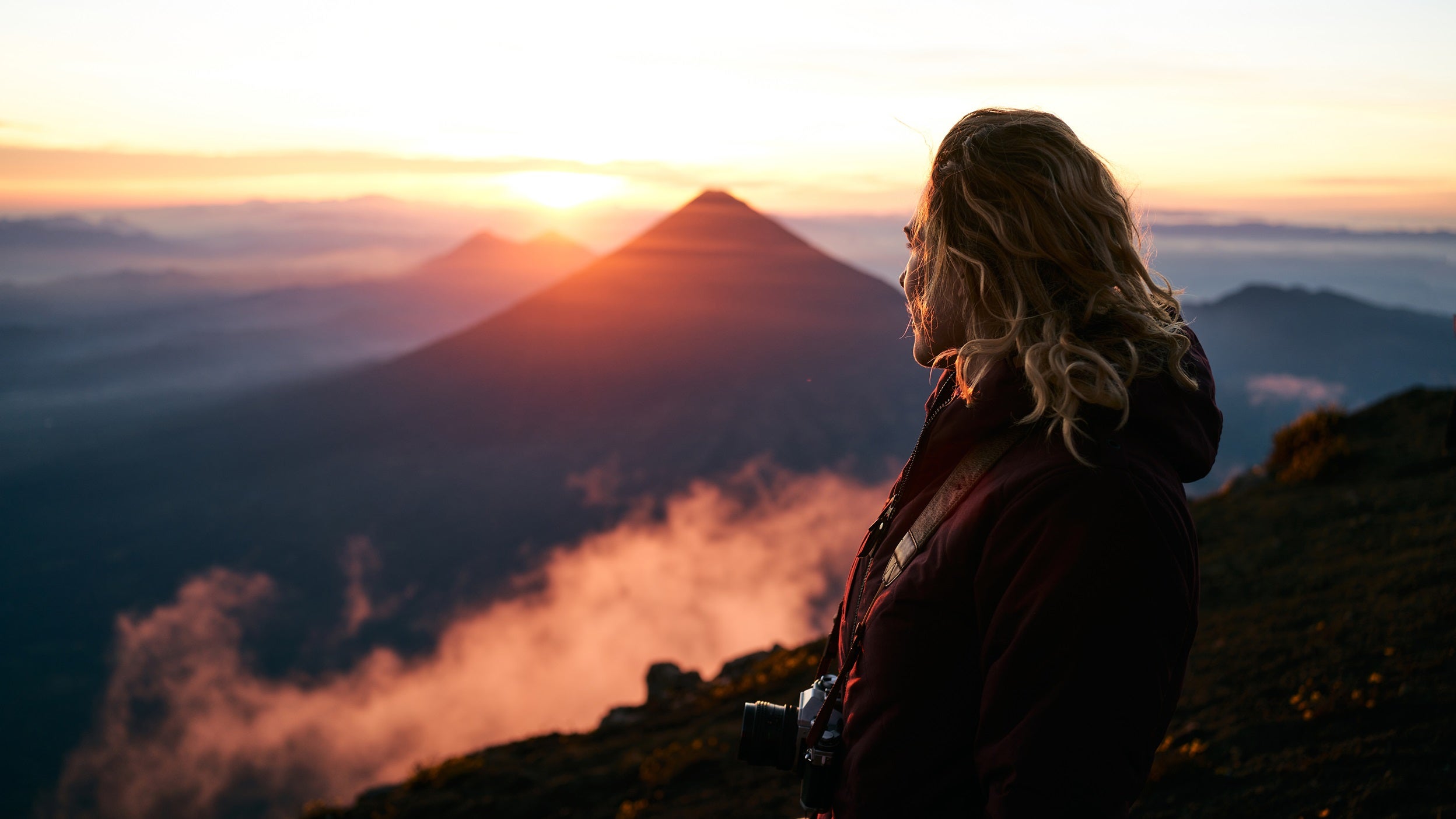 woman on mountain top at sunrise