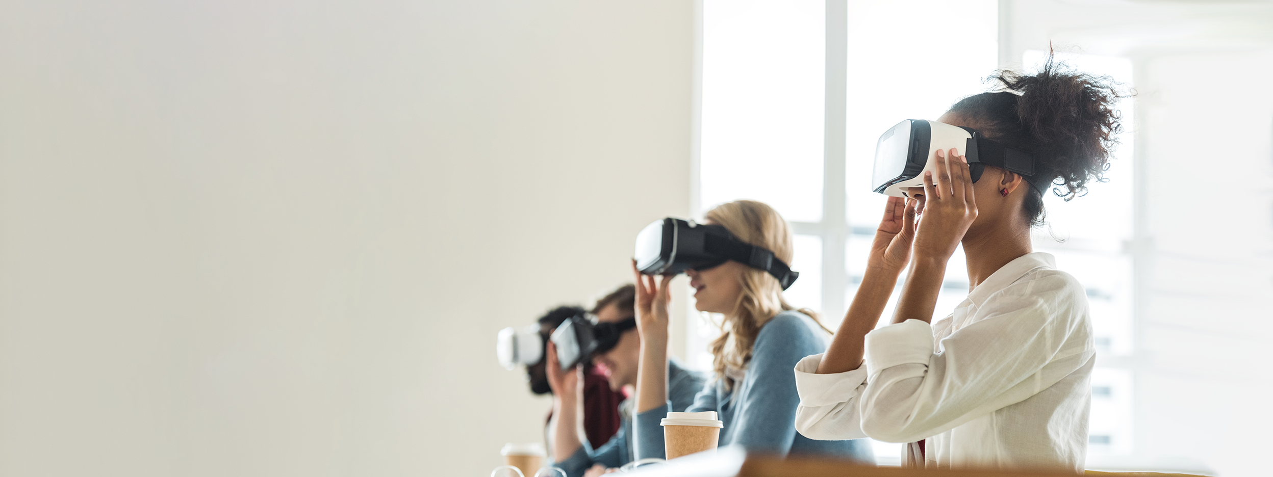 Three women wearing virtual reality headsets