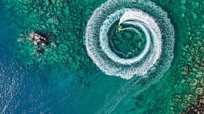 Overhead view of jet ski circling in water