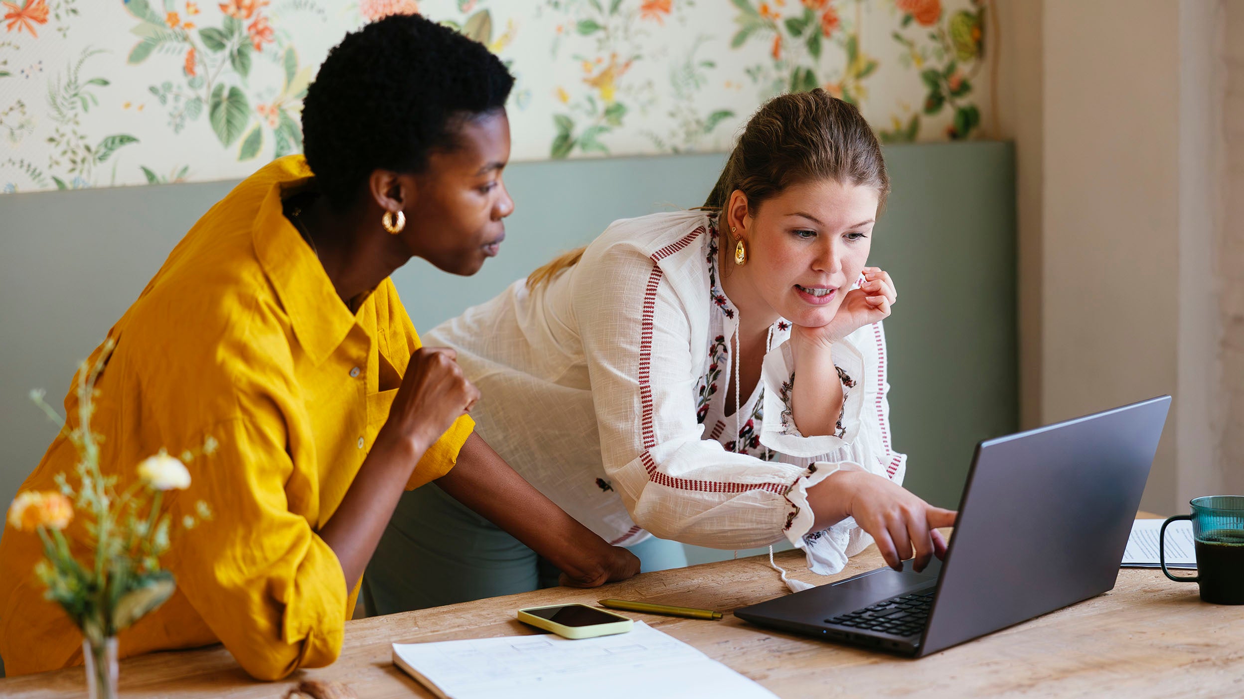 Two people looking at  laptop