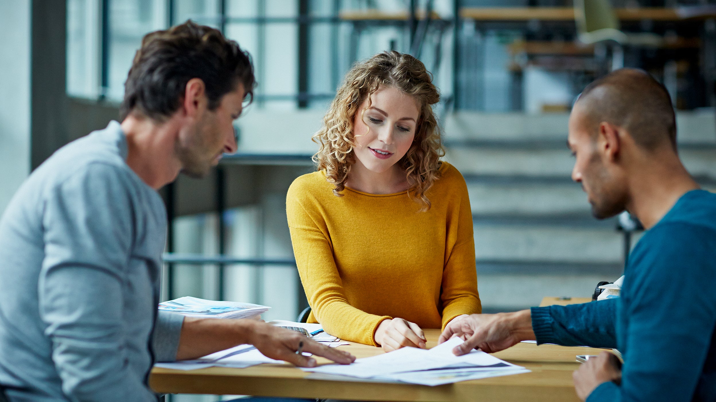 Man and woman looking talking through paperwork