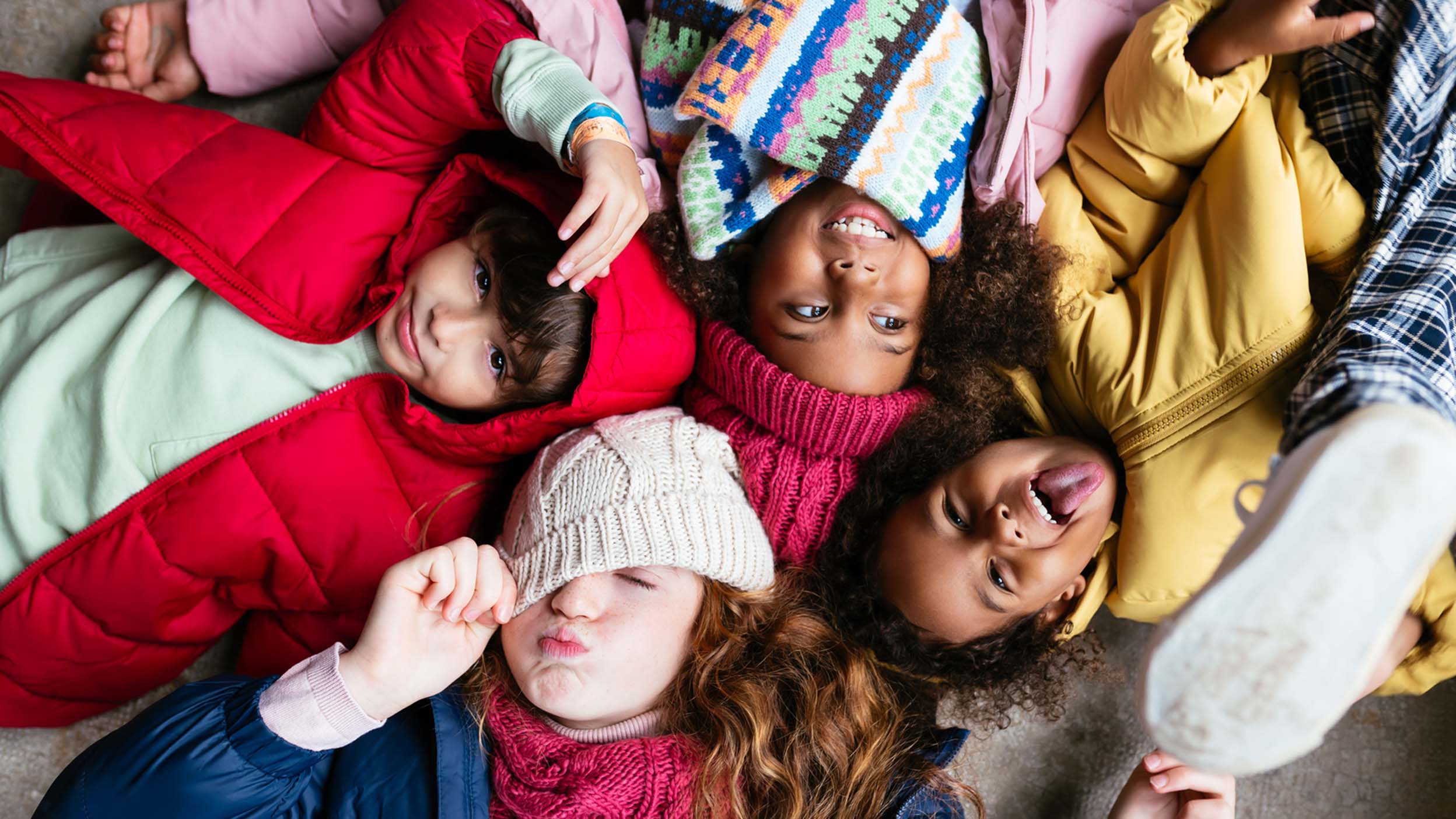 Bunch of kids posing for a camera sleeping