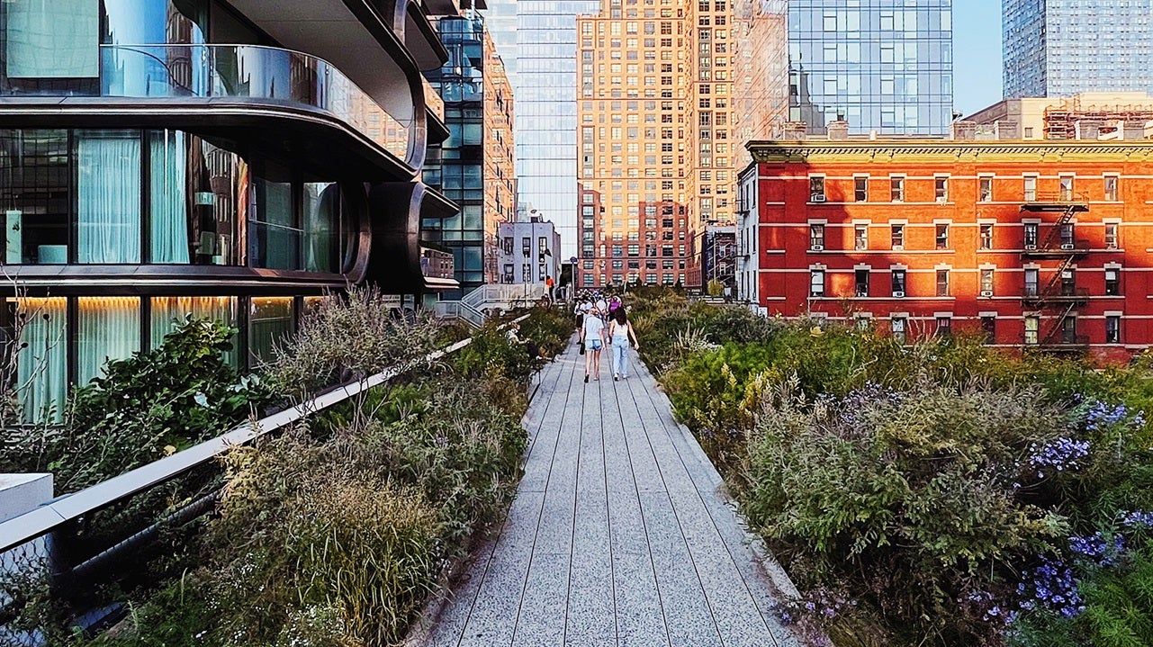 People walking on a pedestrian pathway with buildings on each side