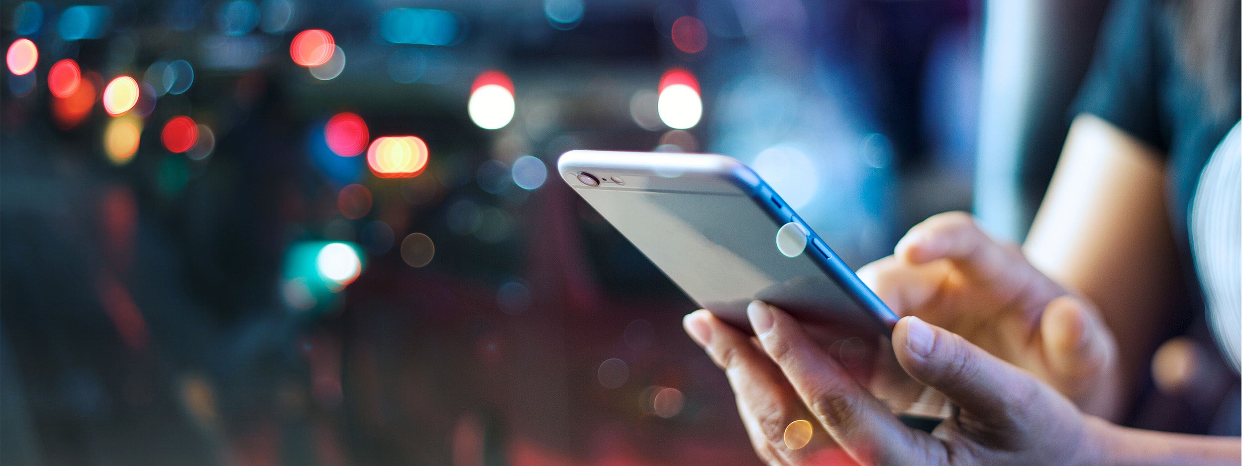 Woman using mobile smartphone in the night light