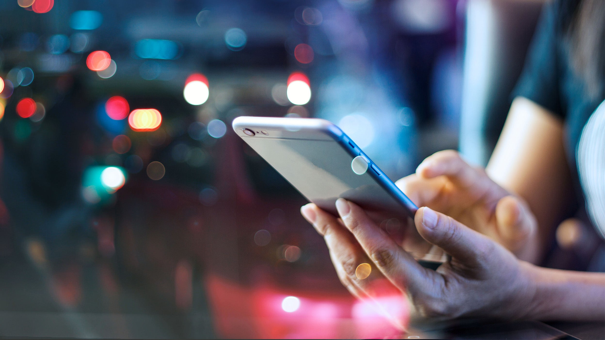 Woman using mobile smartphone in the night light