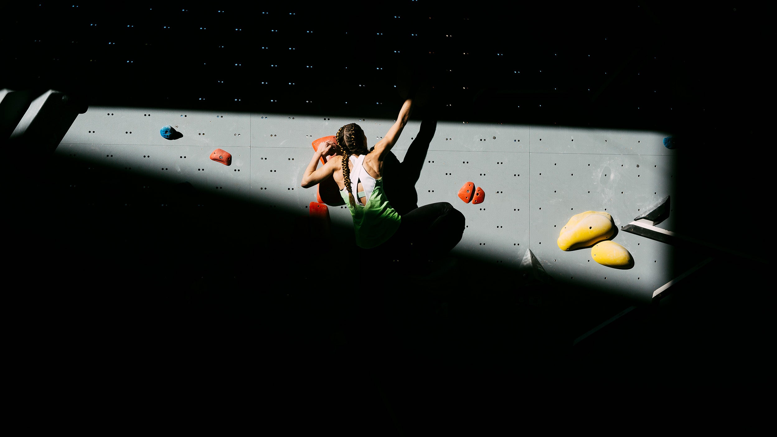 Climber woman climbing a wall 