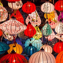 A%20vibrant%20display%20of%20colourful%20hanging%20lanterns%20in%20various%20shapes%20and%20sizes,%20illuminated%20against%20a%20dark%20background.%20The%20lanterns%20feature%20intricate%20designs,%20including%20floral%20patterns%20and%20calligraphy,%20creating%20a%20warm%20and%20festive%20atmosphere.