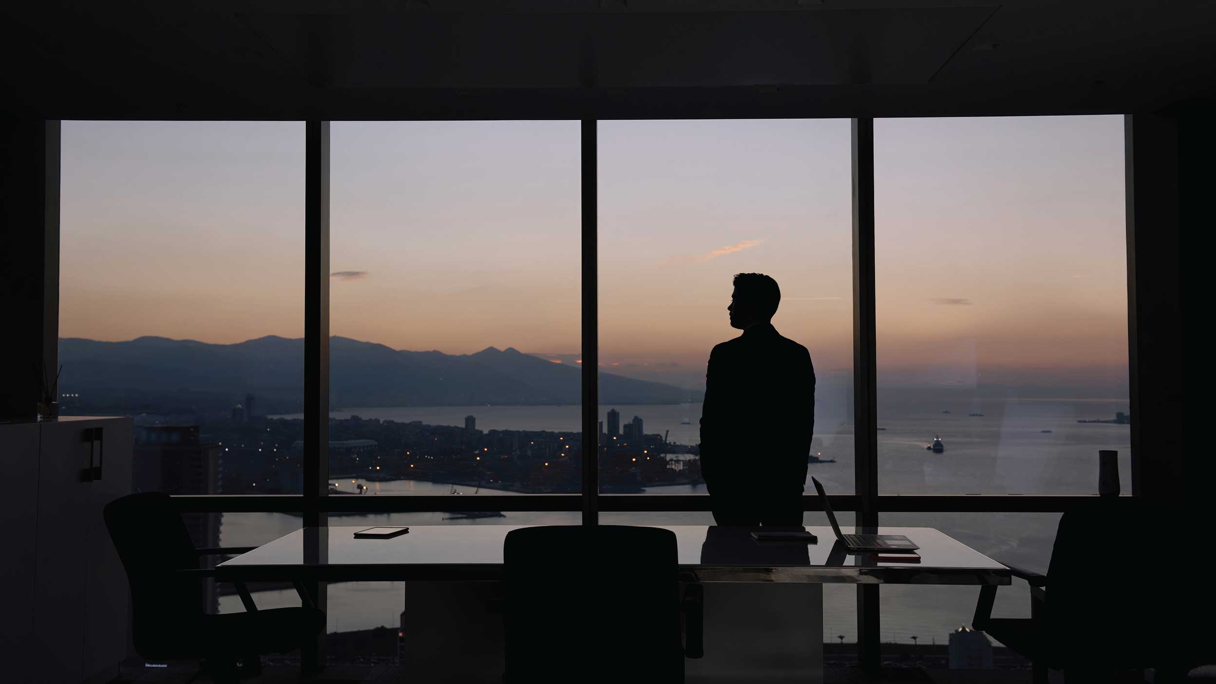 Man looking outside office window