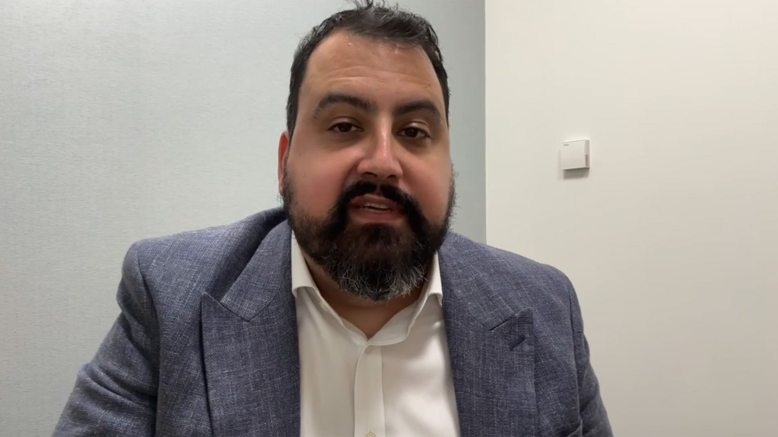 scrrenshot of David Aujla talking in the video