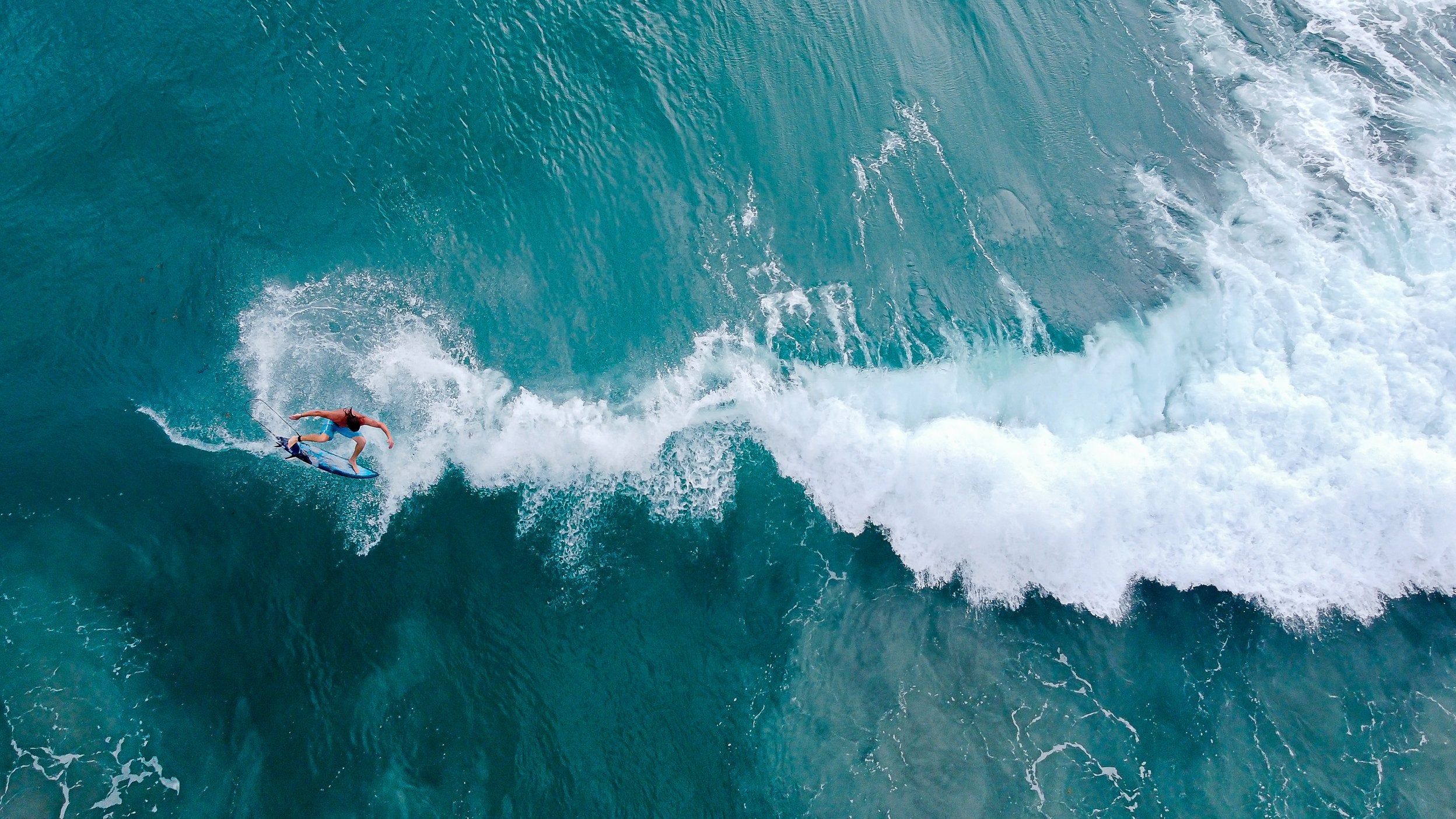 Surfer mid air through a 360 jump