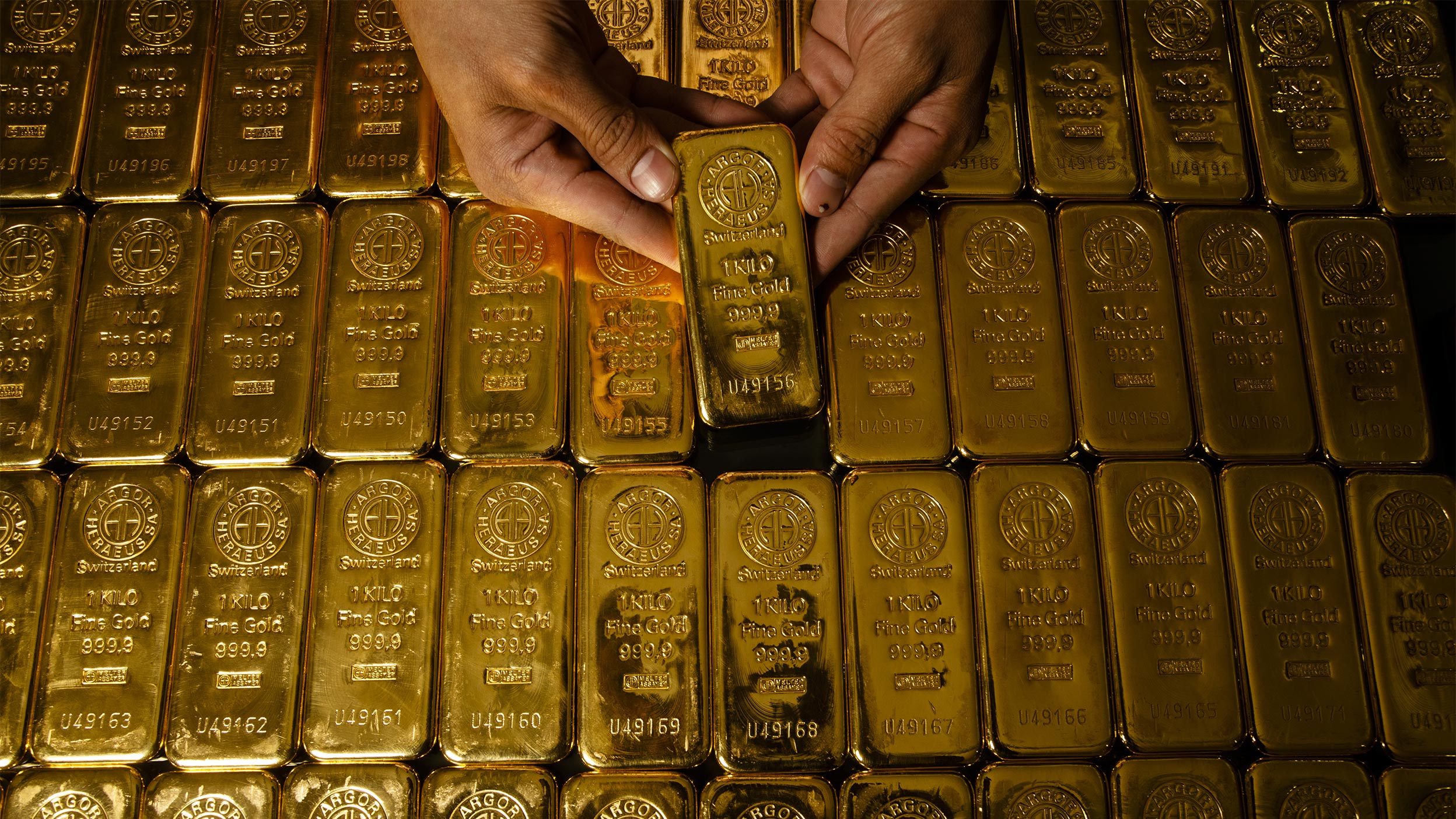 Hand holding gold bar