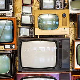 A%20wall%20of%20old%20vintage%20tube%20televisions%20stacked%20up.