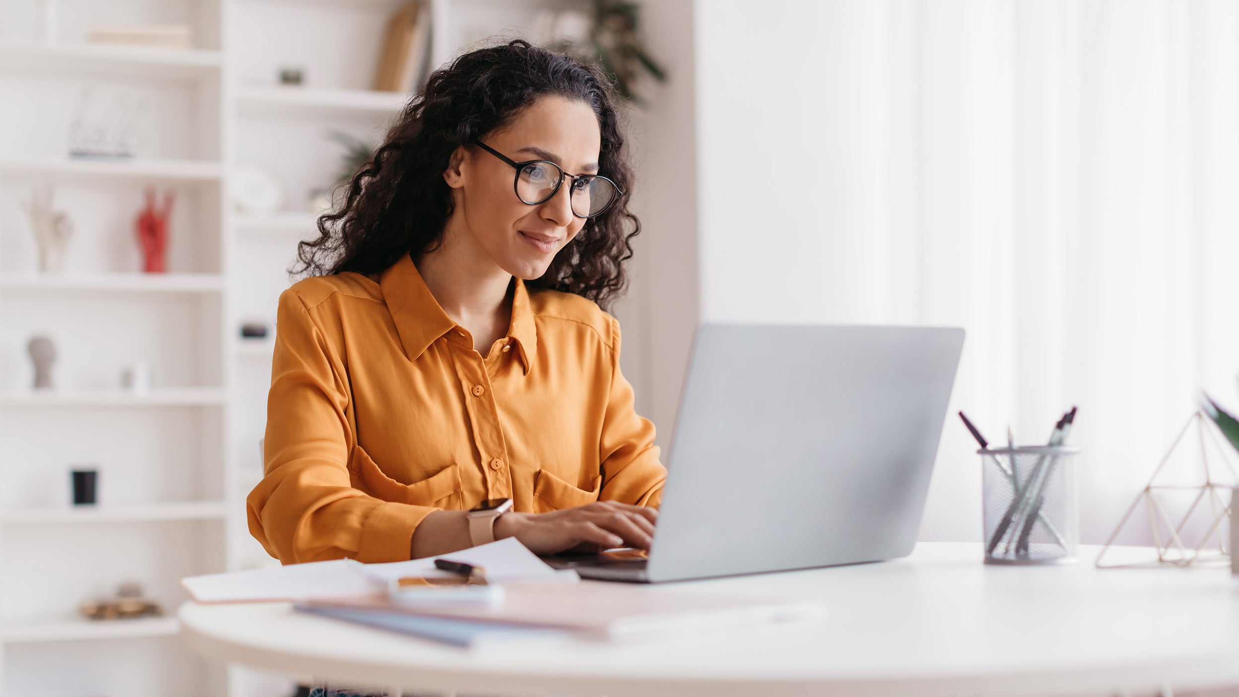  A woman using her laptop to access an artificial intelligence chatbot, one of many AI resources contributing to innovation within the underlying holdings of Invesco QQQ ETF.