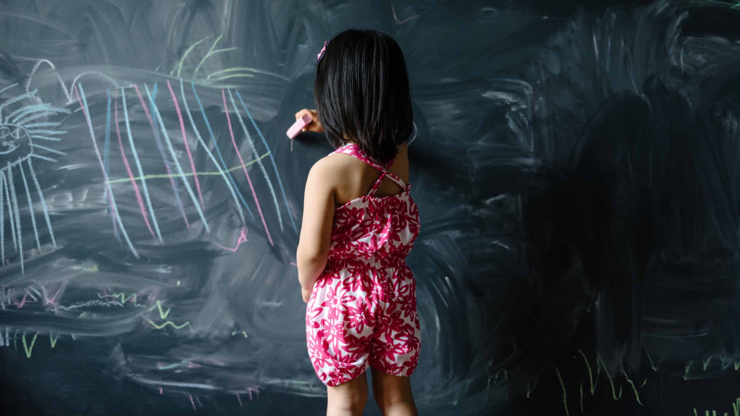 child drawing on a chalkboard, representative of considering important talking points when trading invesco qqq