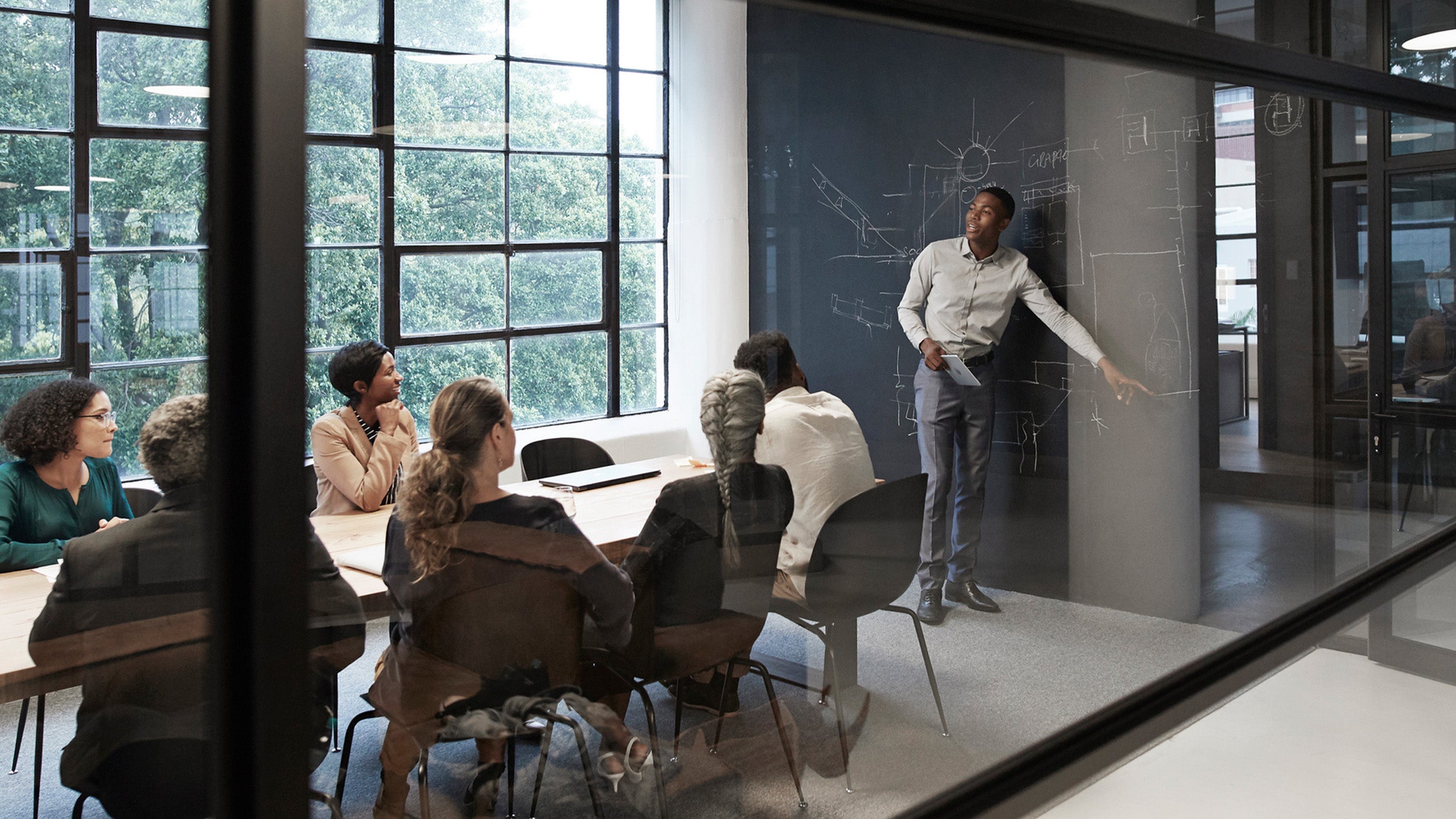 a gathering of coworkers in a meeting room. 