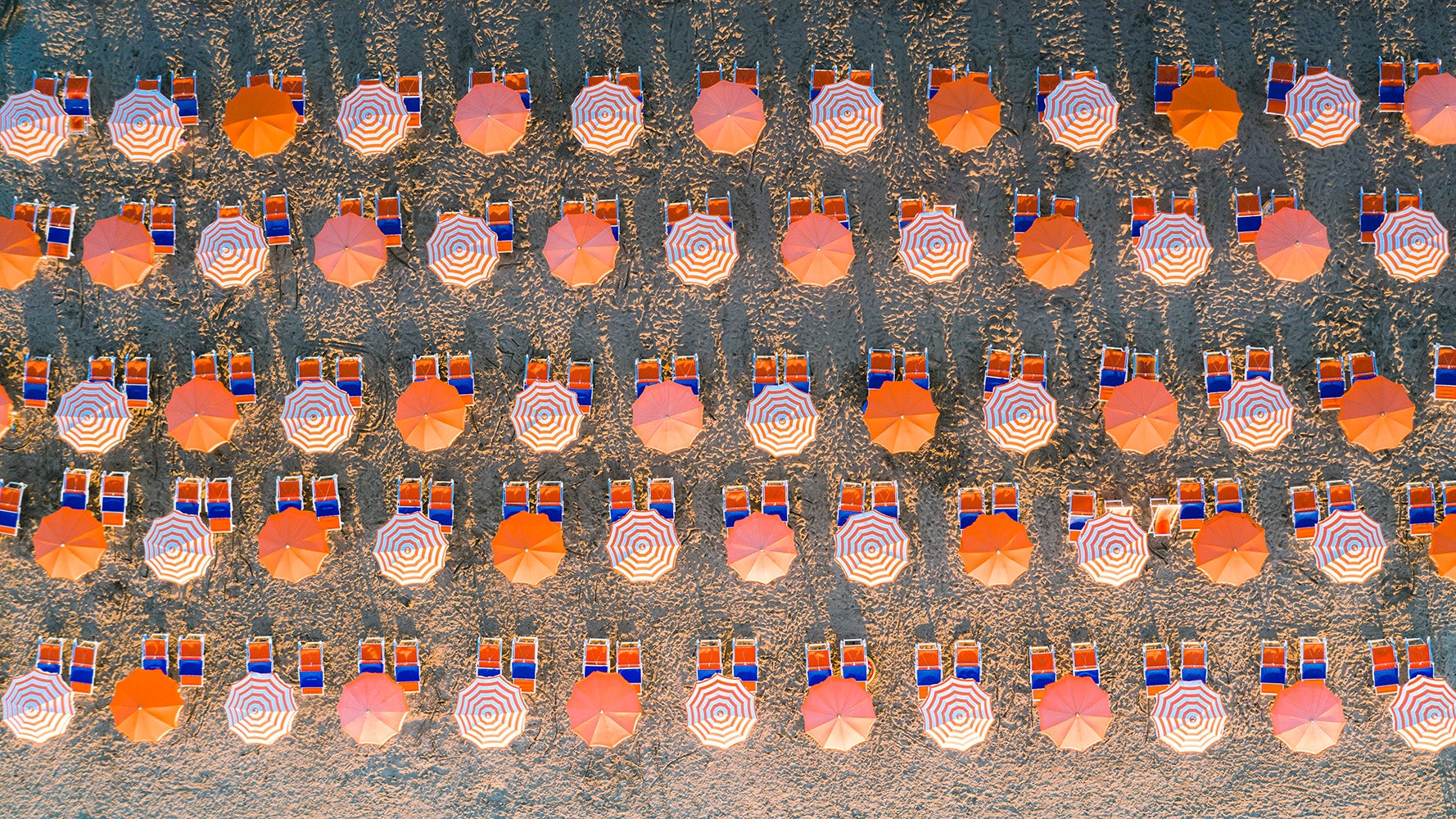 Lot of umbrellas at the beach aerial view