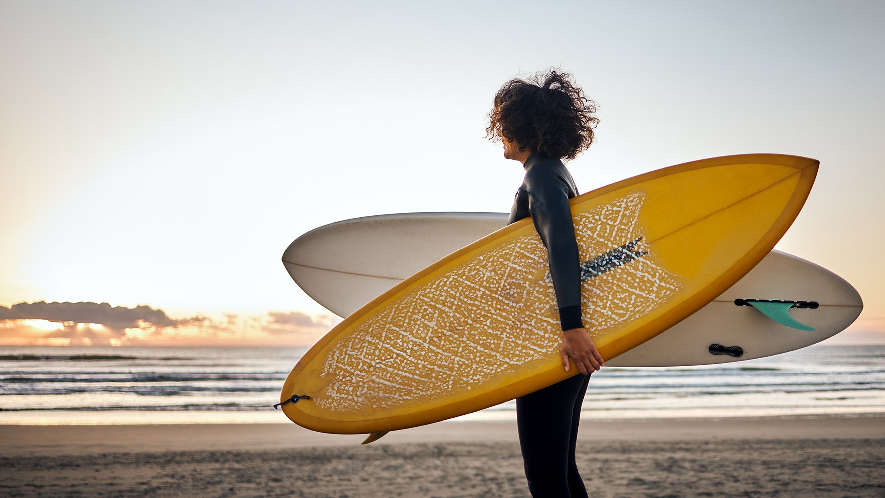 Woman carrying surf boards