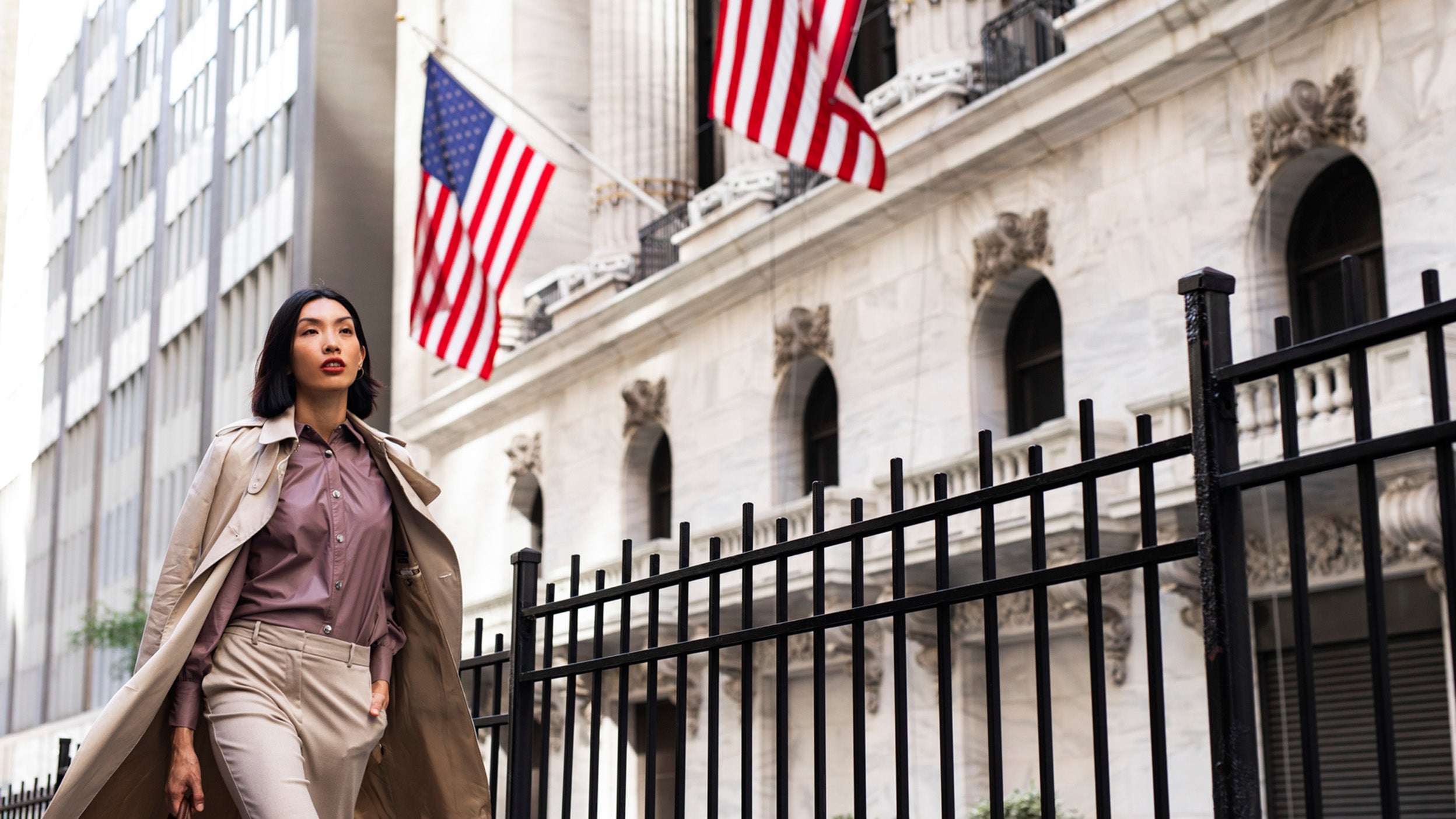 Woman walking infront of a US buidling