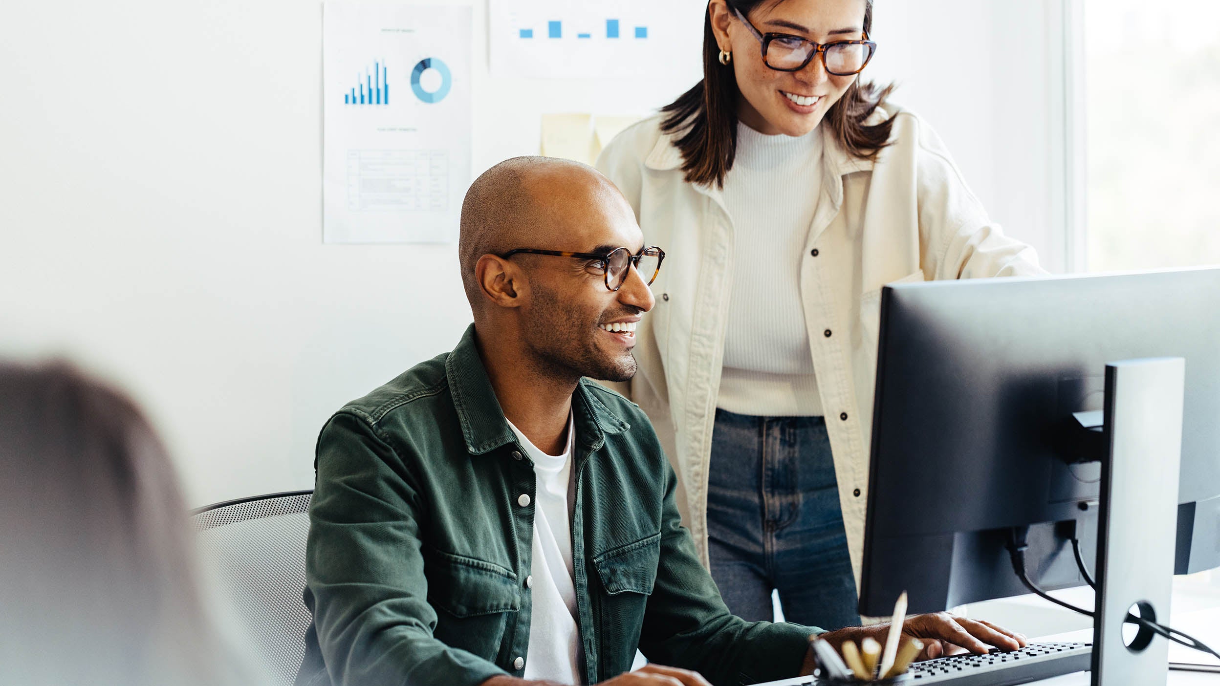 Two people working in office