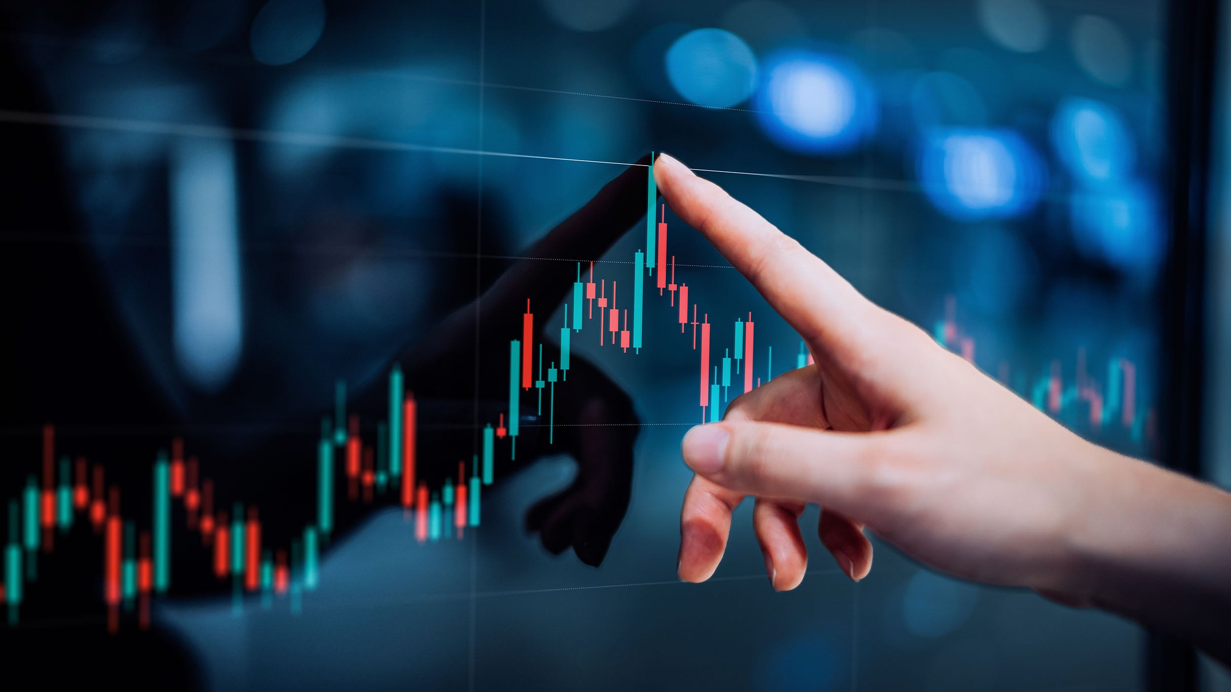 Close up of female hand touching stock market analysis digital display screen, analyzing investment and financial trading data in candlestick chart on a touch screen interface. 