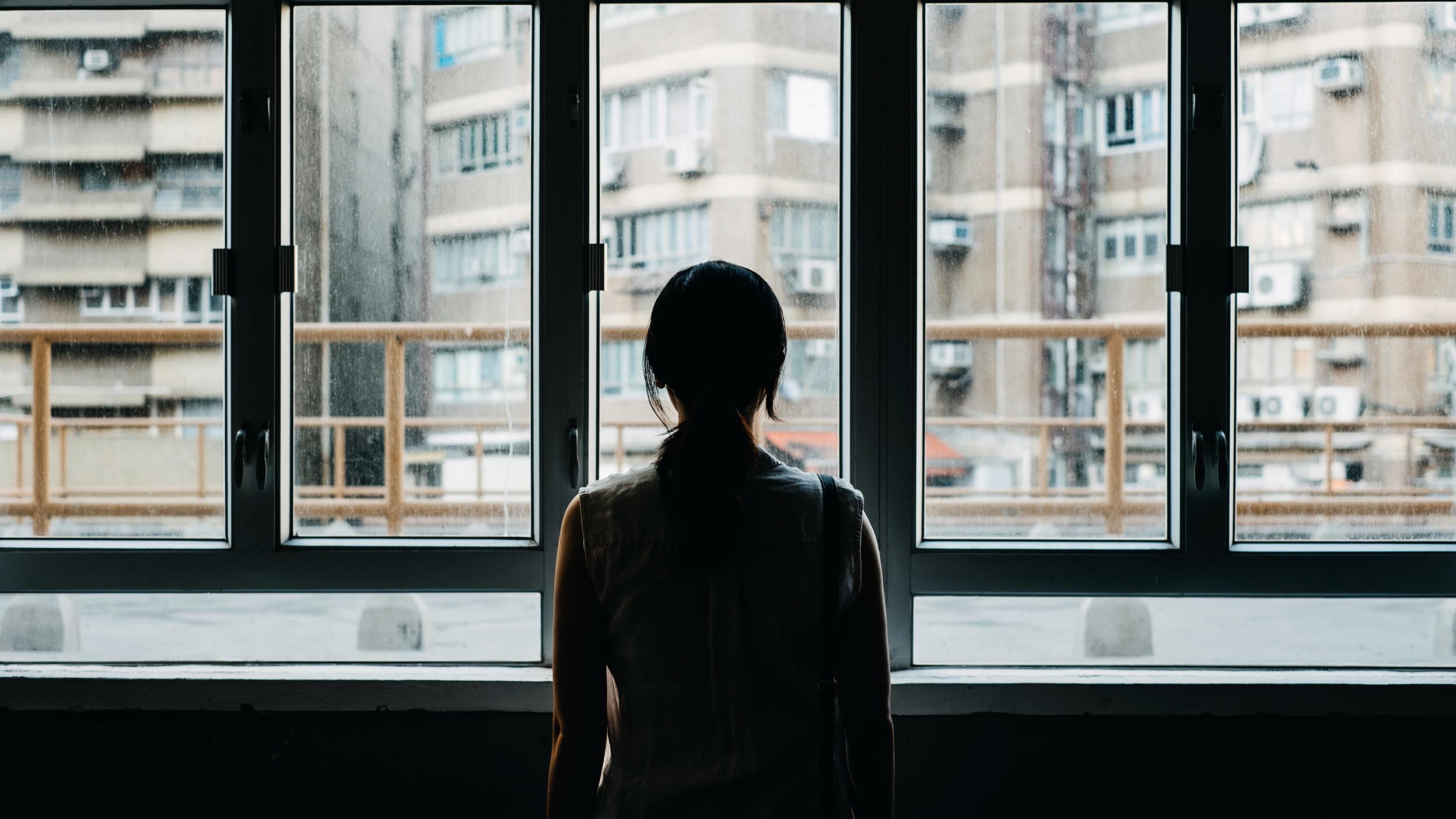 women watching through glass window