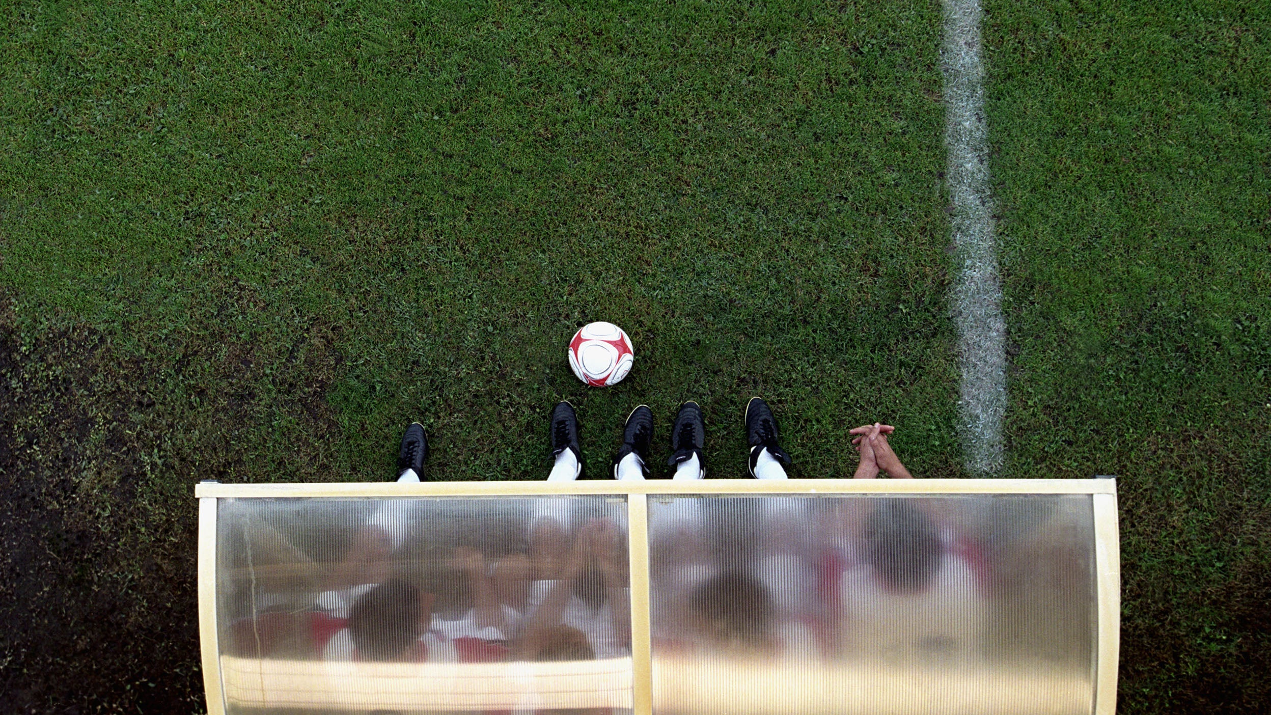 Soccer players sitting on the sidelines