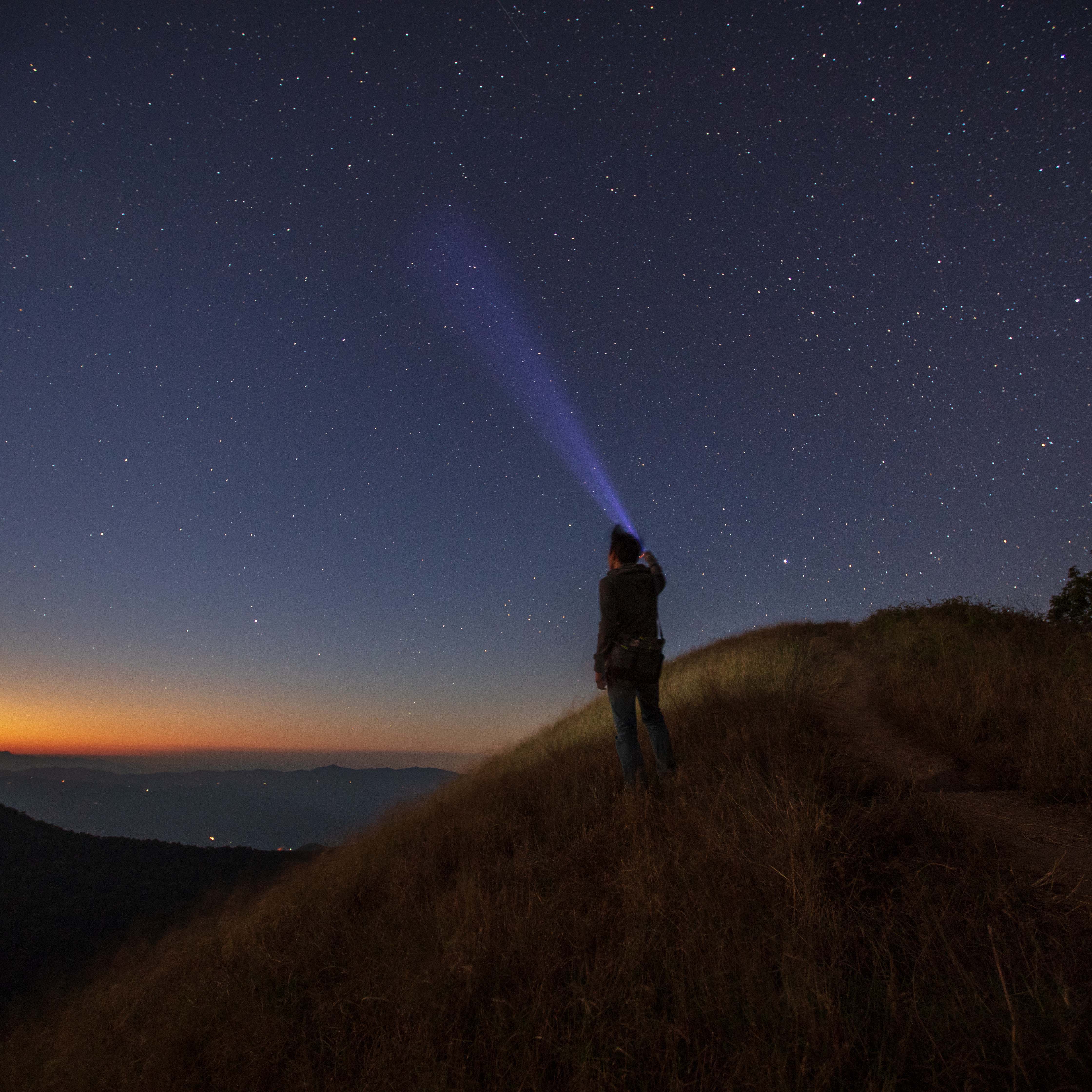 Man%20pointing%20torch%20at%20the%20sky