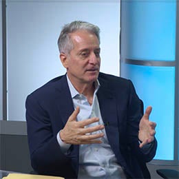 Two%20males%20sitting%20in%20a%20studio%20at%20a%20table%20in%20conversation%20with%20one%20another.%20There%20are%20notes%20on%20the%20table.