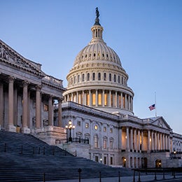 The%20US%20Capitol%20building%20at%20dusk%20with%20the%20American%20flag%20at%20half-staff.